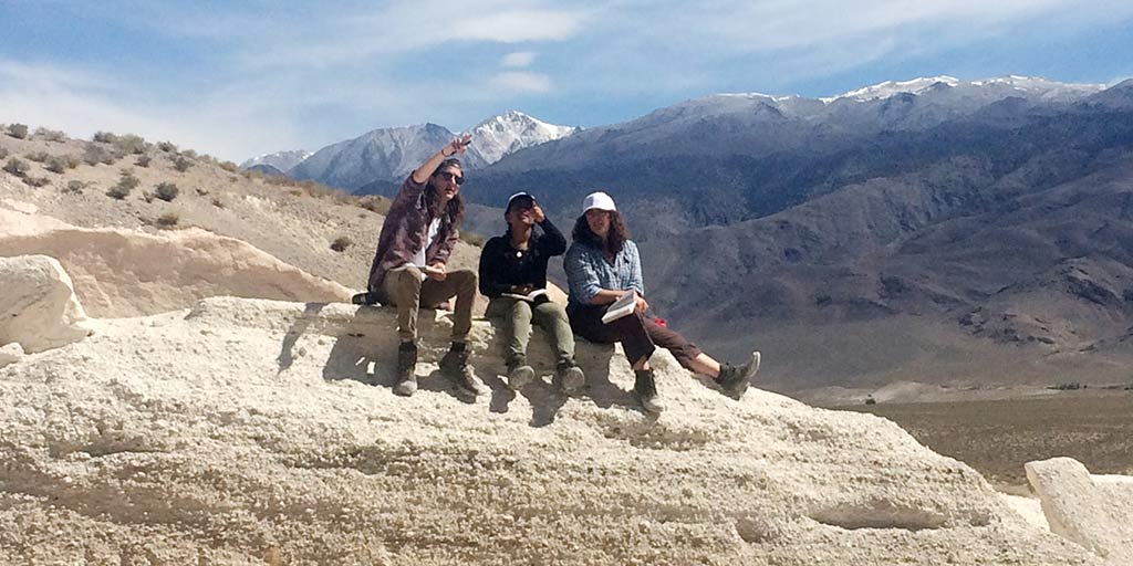 Students sitting on a mountainside