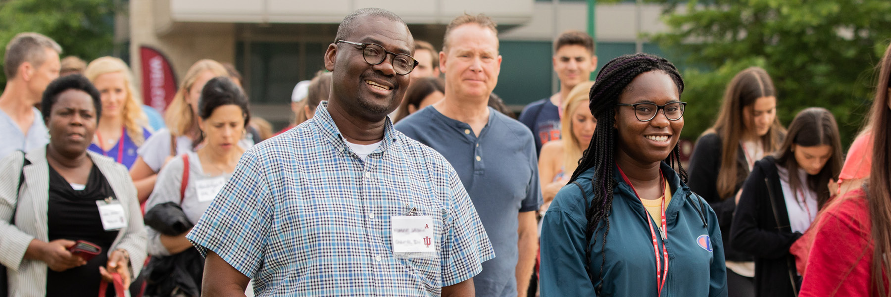 A family member and their student smile at the camera during New Student Orientation.