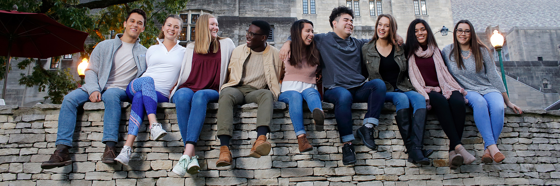 Friendly students on a limestone wall